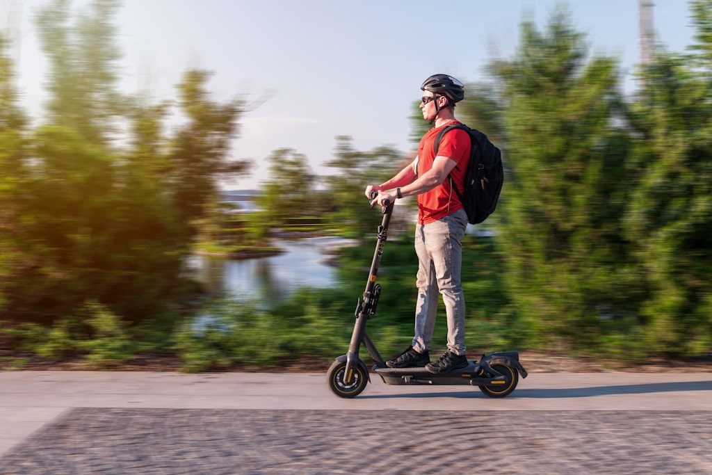 Young girl riding electric scooter